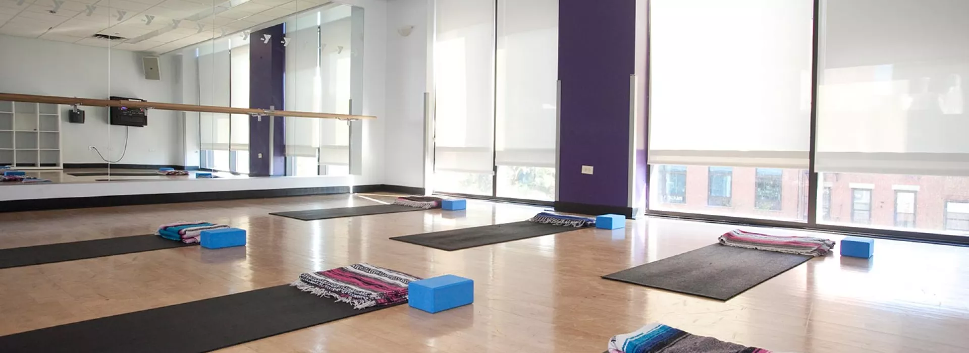 Group exercise studio with yoga mats and Pilates equipment at Dodge YMCA in Brooklyn