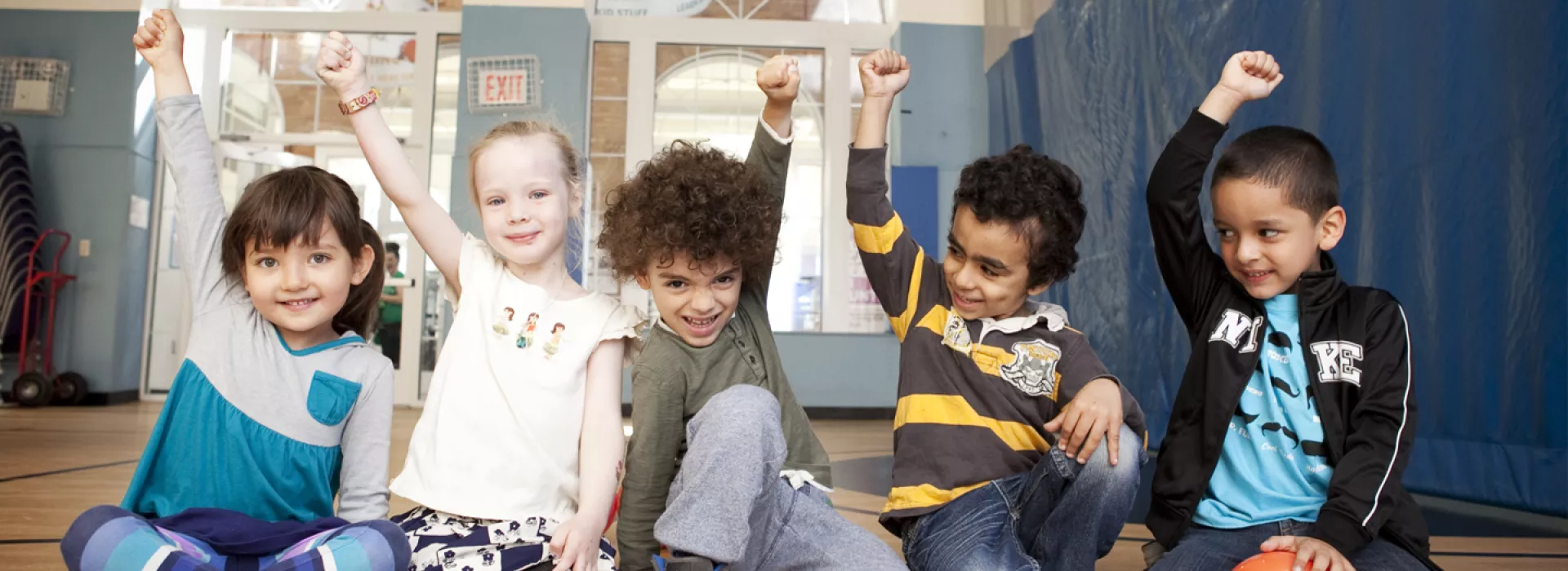Five kids raising their fists up.