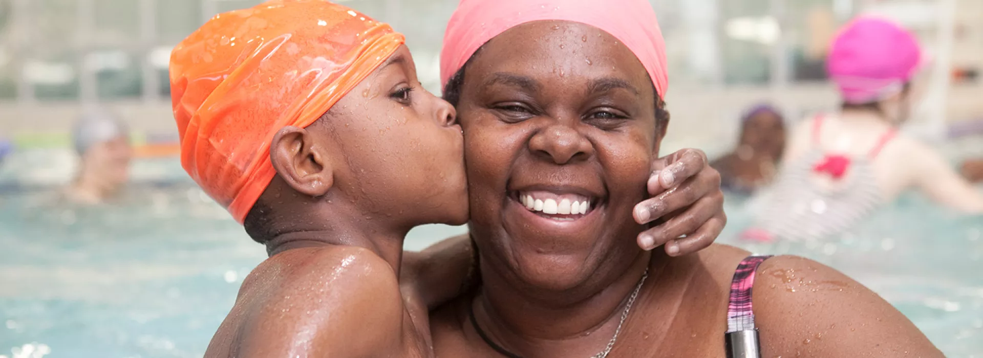 Mom and son enjoying open swim in the pool at the YMCA in Brooklyn