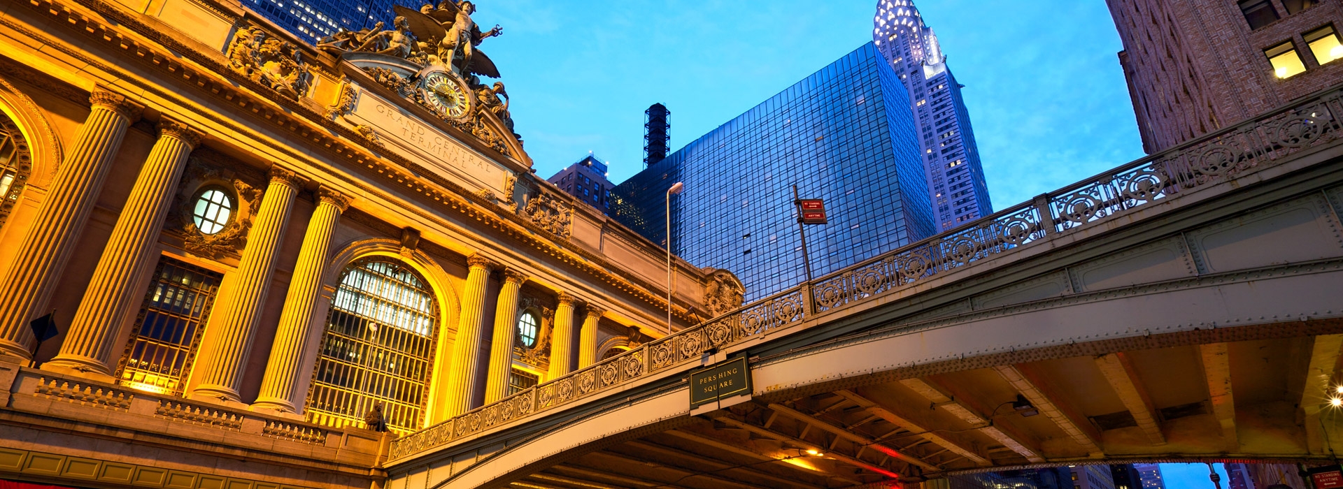 Grand Central Station in Manhattan's midtown east, near the Vanderbilt YMCA Guest Rooms, lit up at dusk.