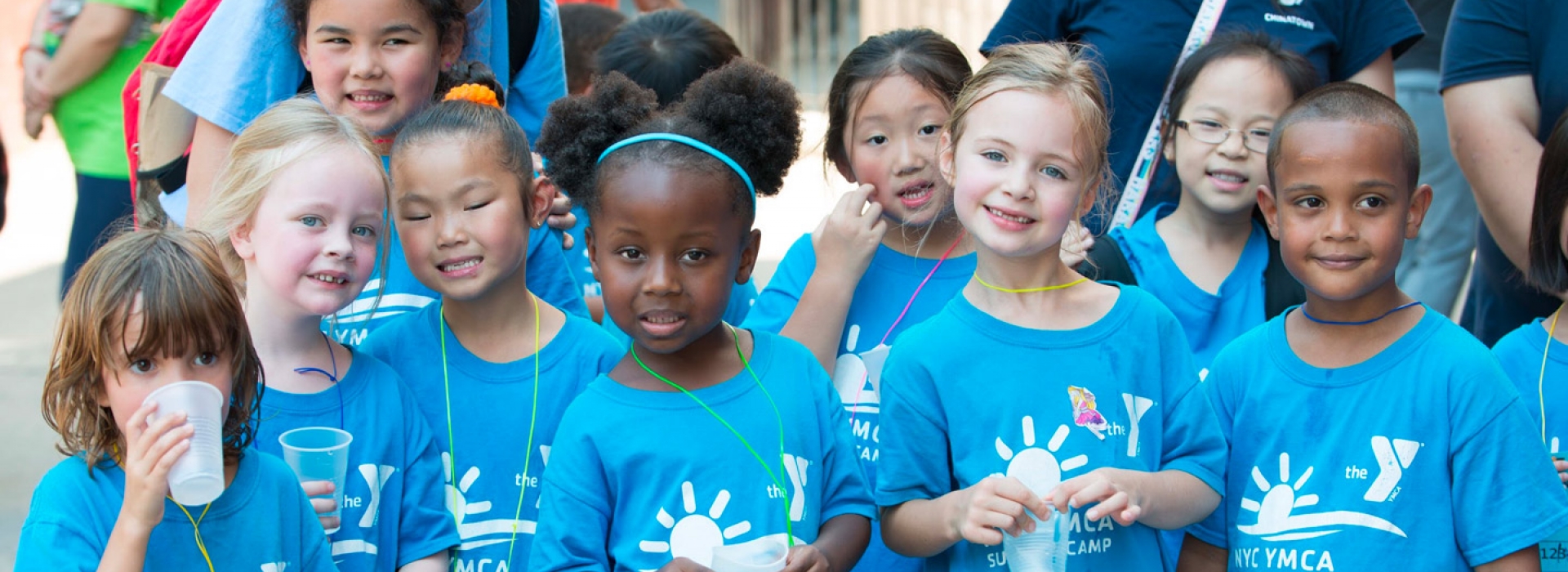 A group of kids outside at the Chinatown YMCA summer day camp.