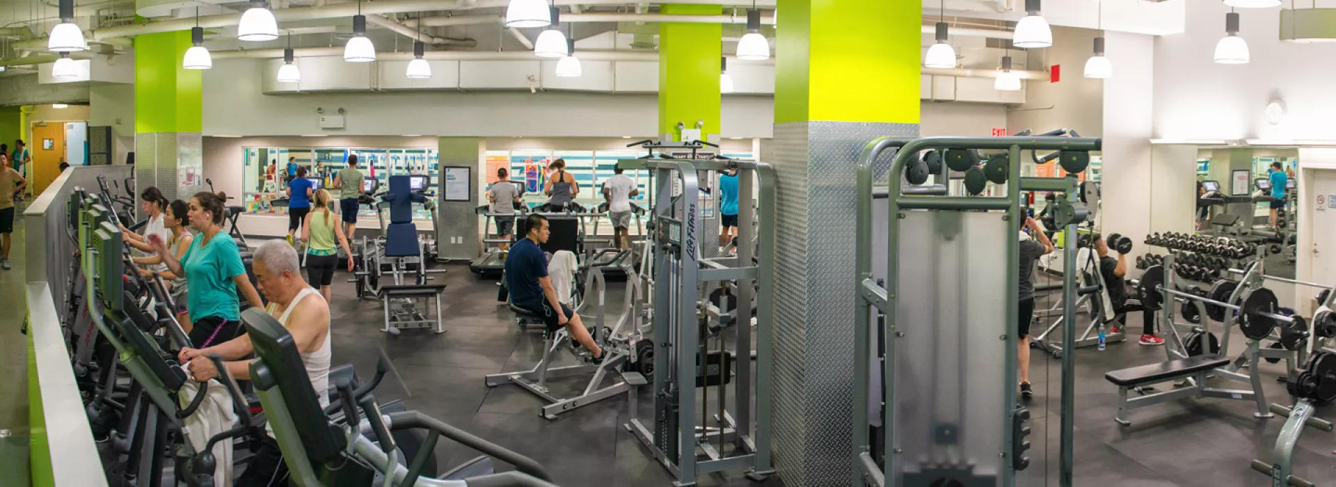 Strength training and cardio equipment and free weights at the Chinatown YMCA.