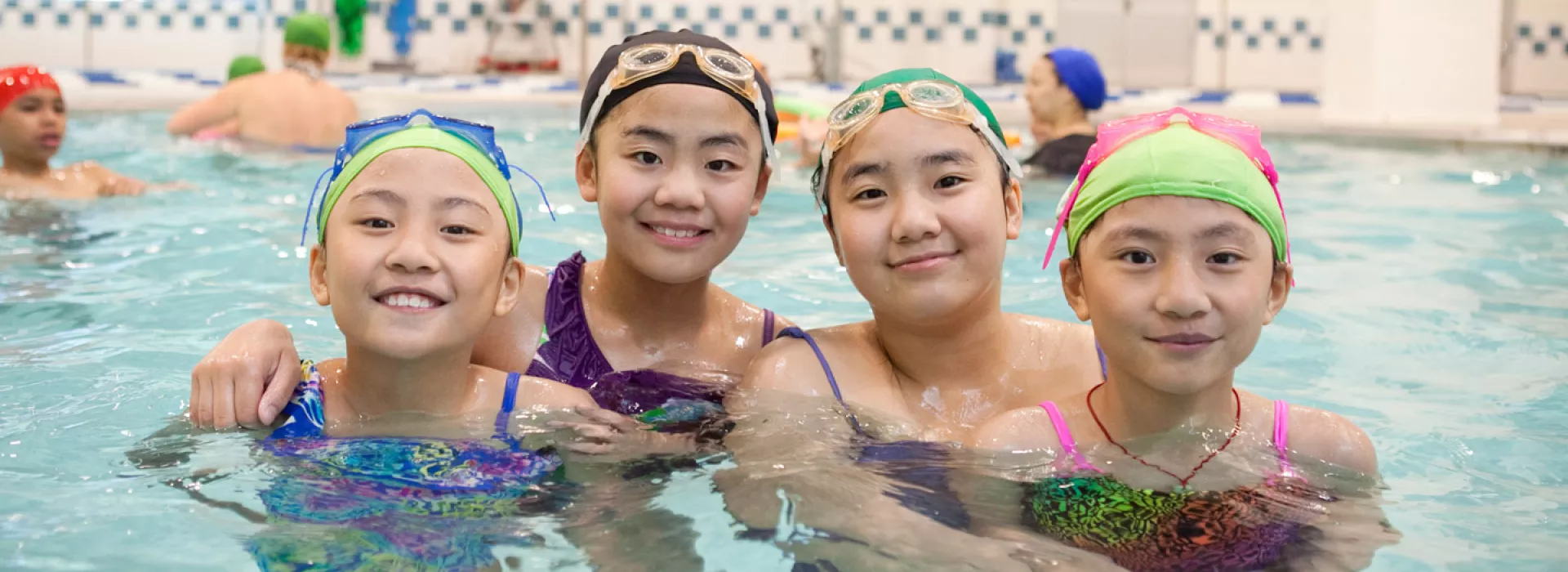 4 girls swimming in the Coney Island YMCA pool.