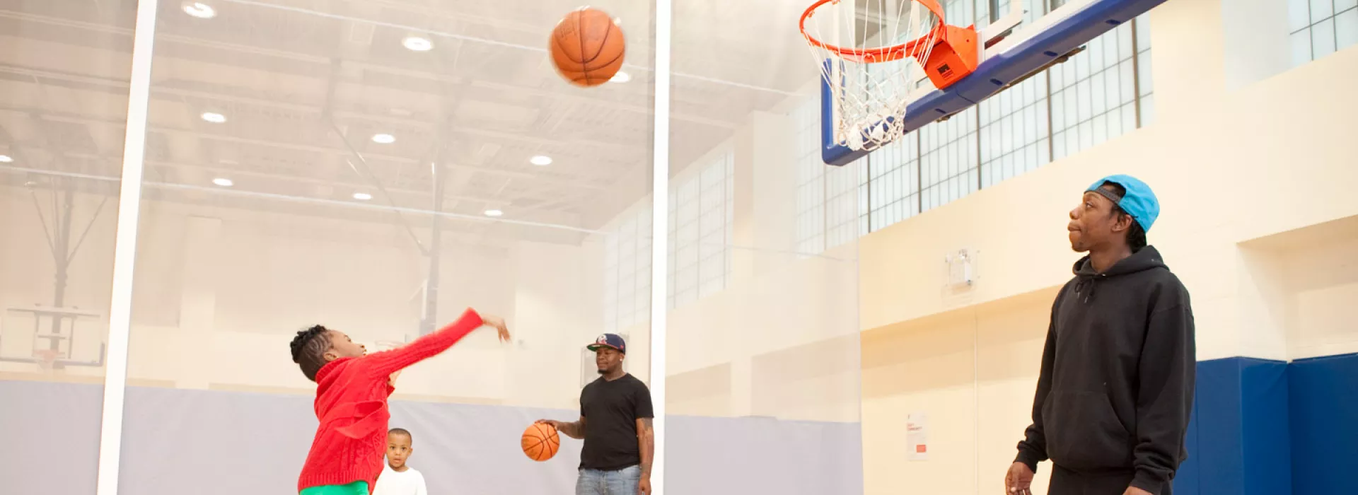 A child shoots a basketball in the Coney Island YMCA gymnasium.