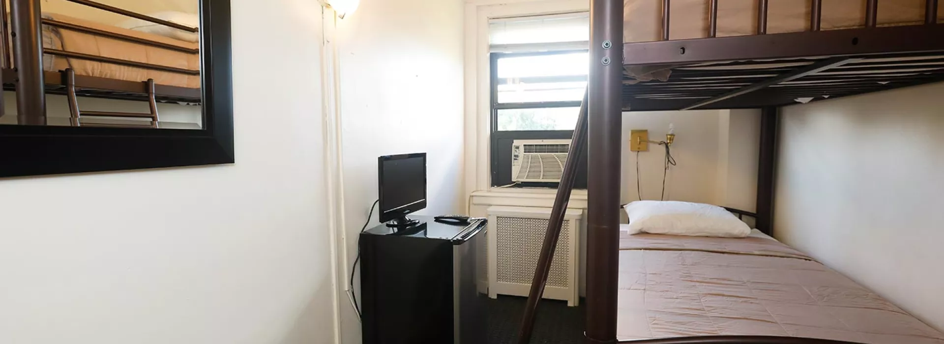 Double bed at guest rooms in Flushing YMCA in Queens
