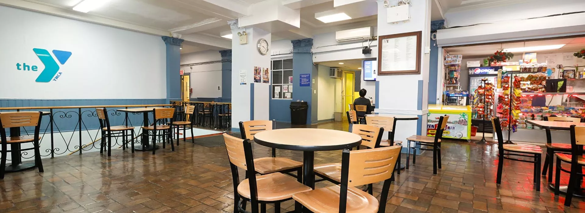 Cafe with snacks and tables at the Flushing YMCA in Queens