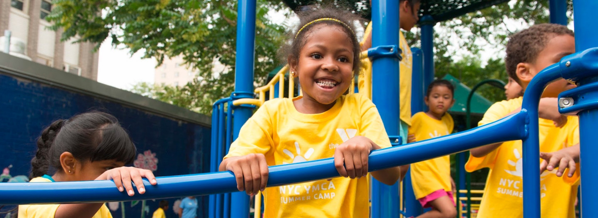 Children play at a playground during a Greenpoint YMCA summer day camp.