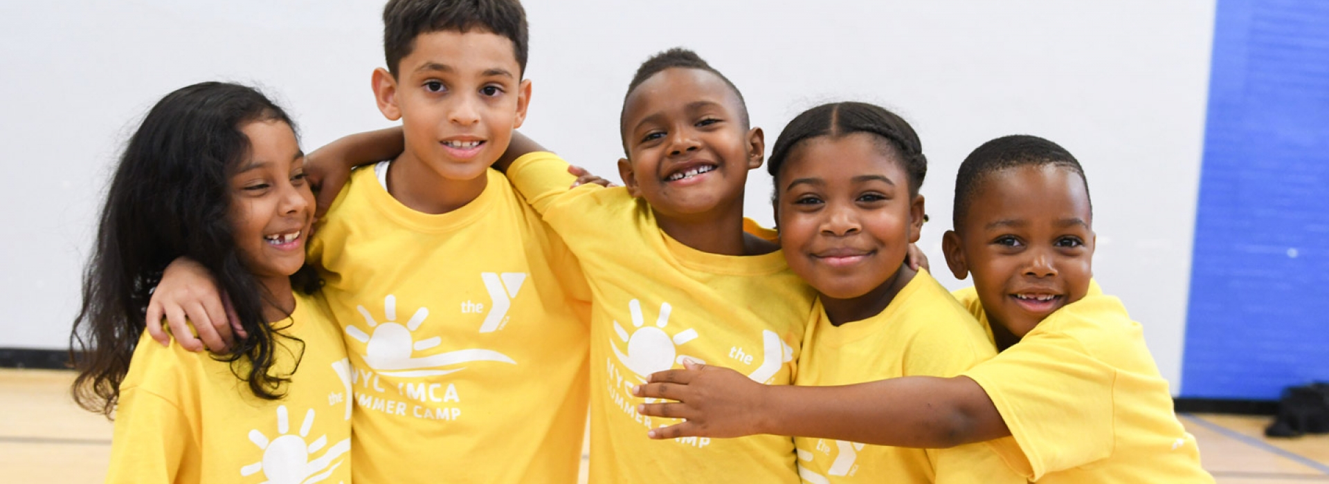 A group of smiling kids at the Jamaica YMCA.