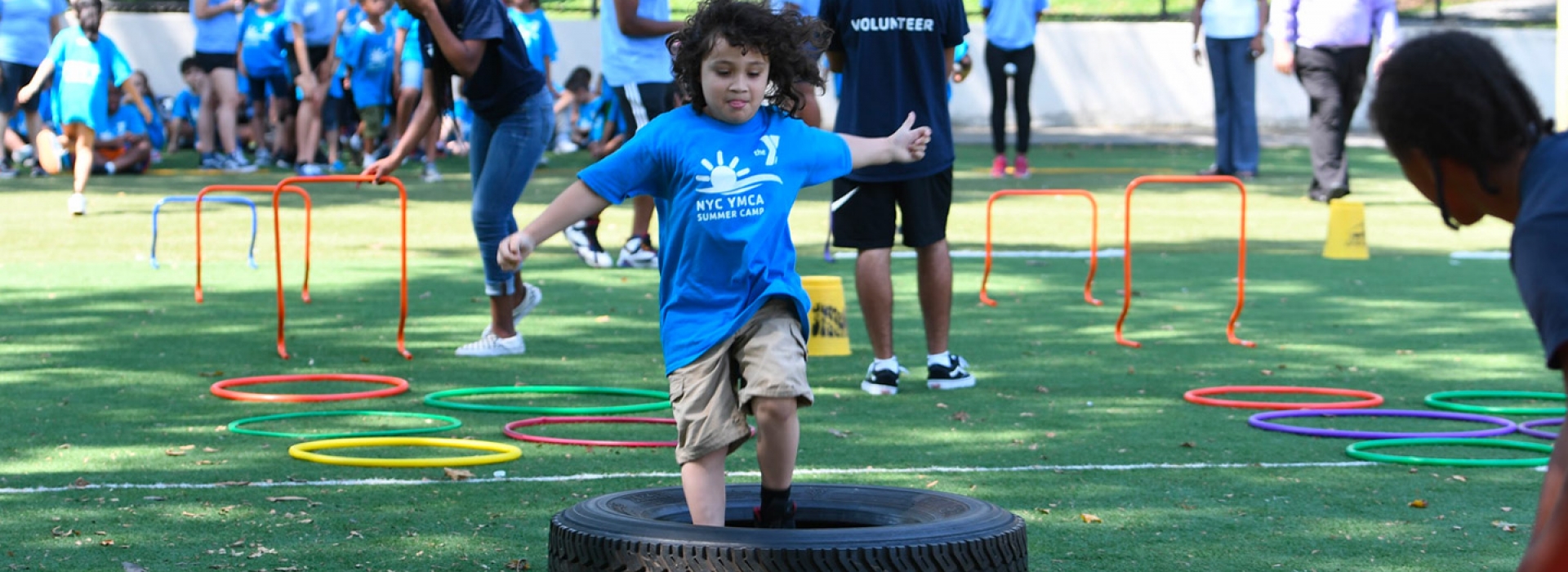 A young camper runs through an obstacle course at the North Brooklyn YMCA summer day camp.