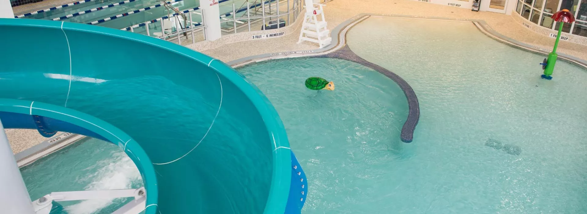 Indoor pool and water slide at Rockaway YMCA in Queens