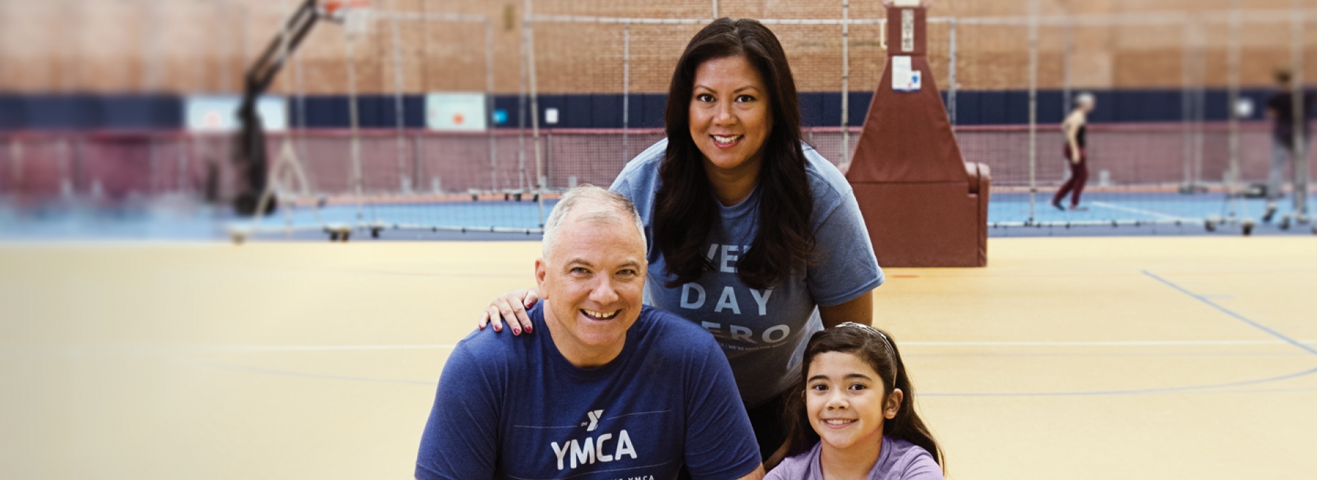 A family on a basketball court at the YMCA.