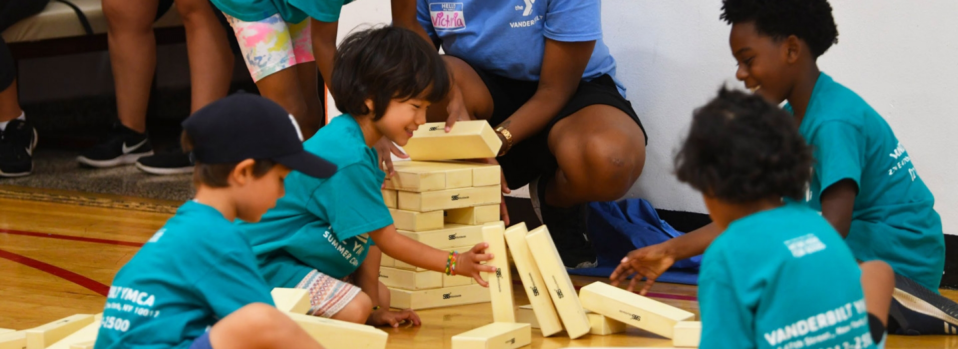 Summer campers play giant Jenga at the Vanderbilt YMCA summer day camp.