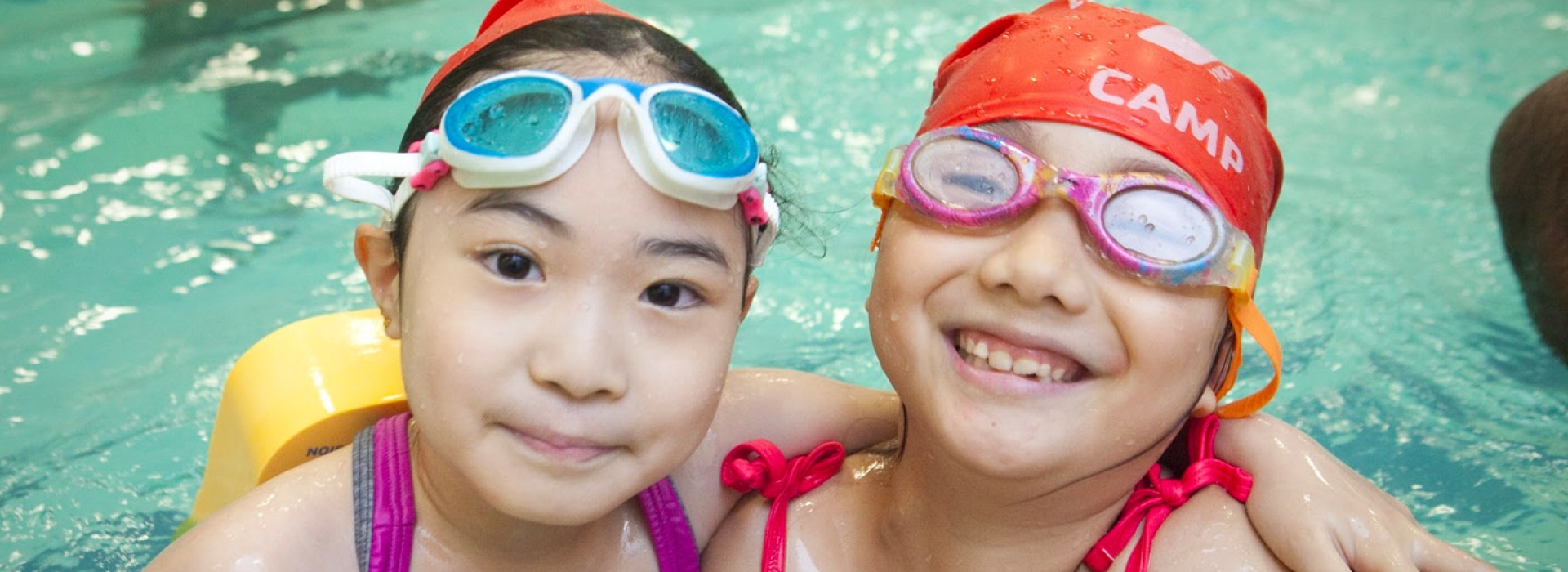 Two girls in the pool at Vanderbilt YMCA summer day camp.