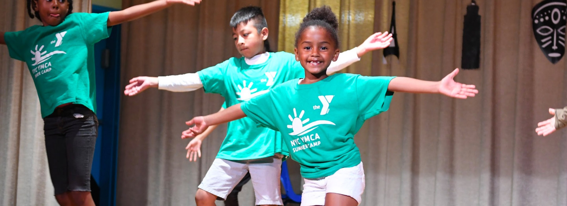 Kids performing on a stage during the West Side YMCA summer day camp.