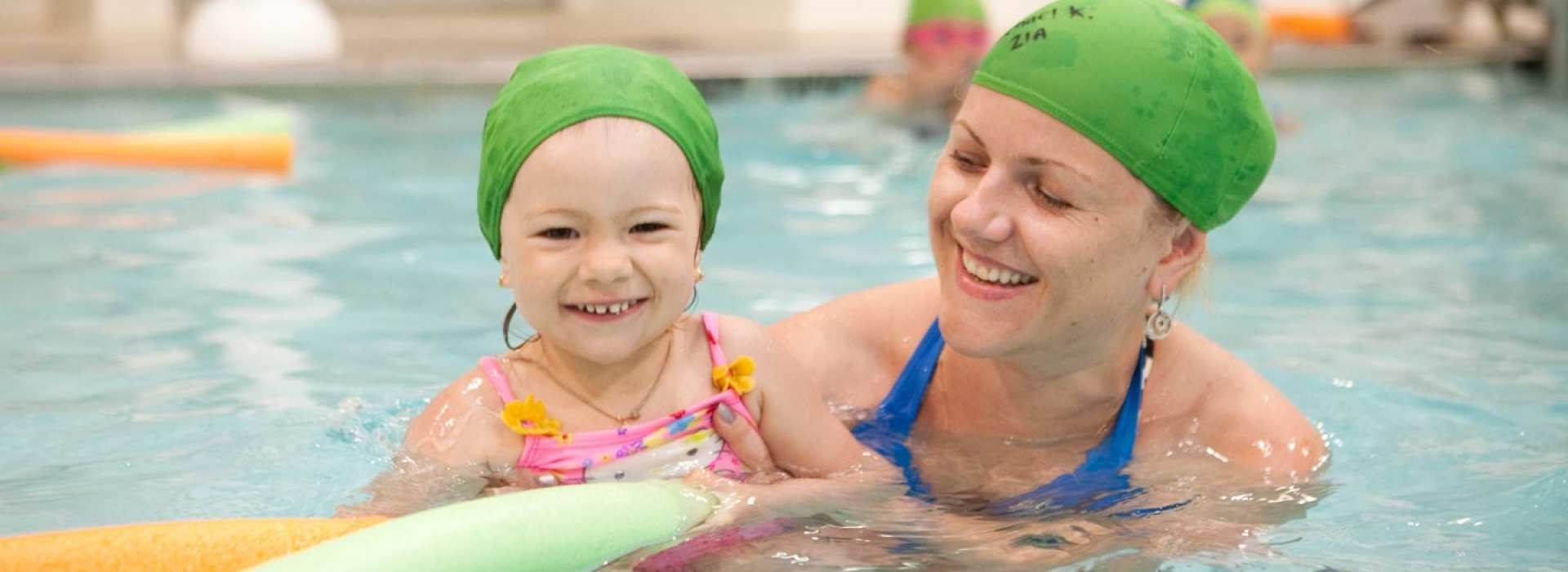 Mom and baby swimming in YMCA indoor pool