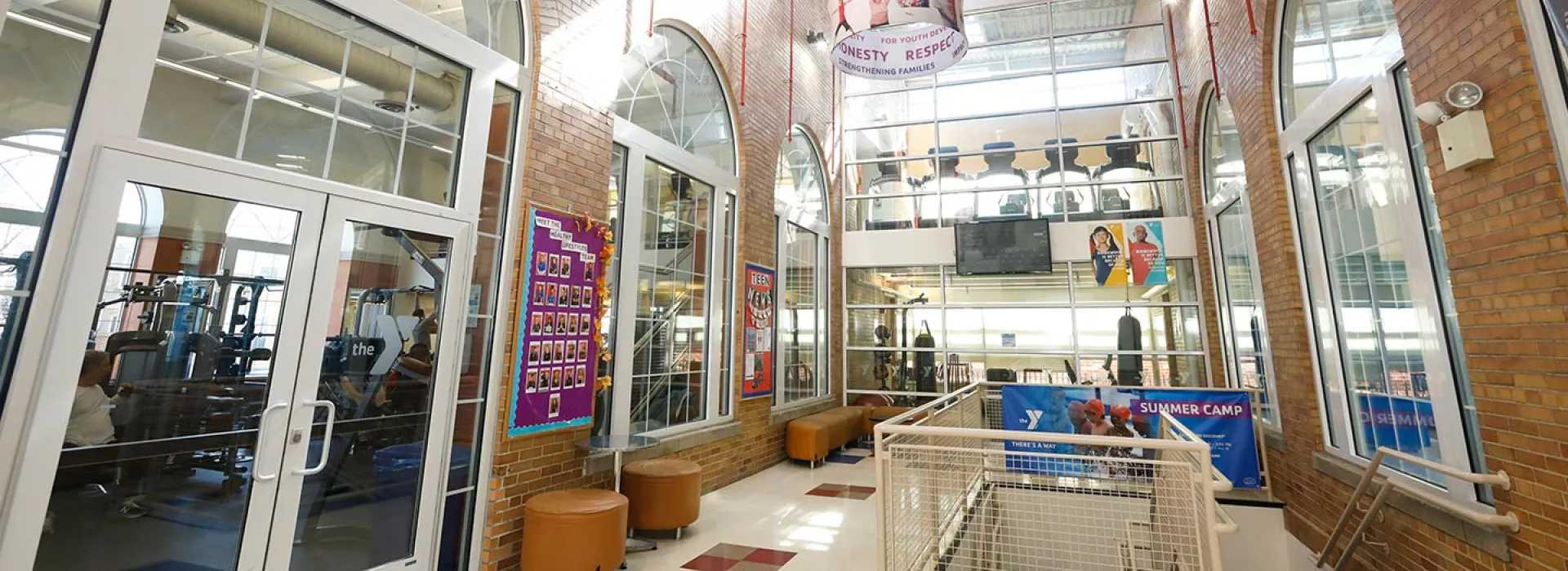 Lobby of Ridgewood YMCA with view of staircase and strength training room