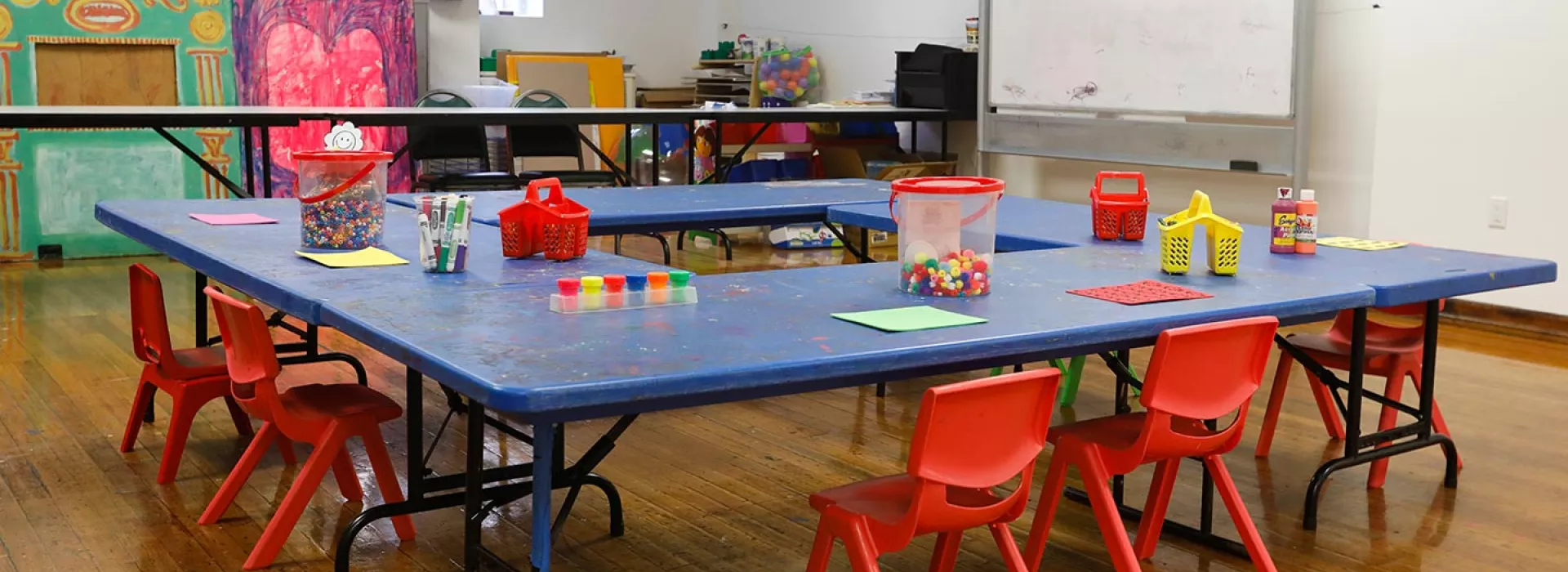Kid sized table with chairs and art supplies at the Park Slope Armory YMCA