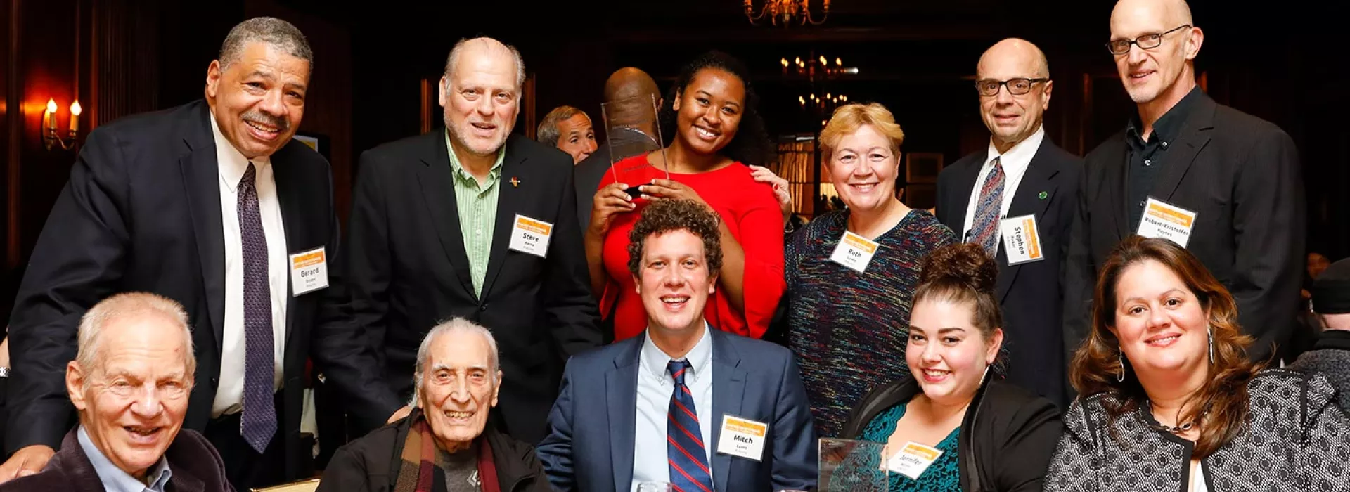 McBurney YMCA staff and board members gathered around table at Heritage Society event