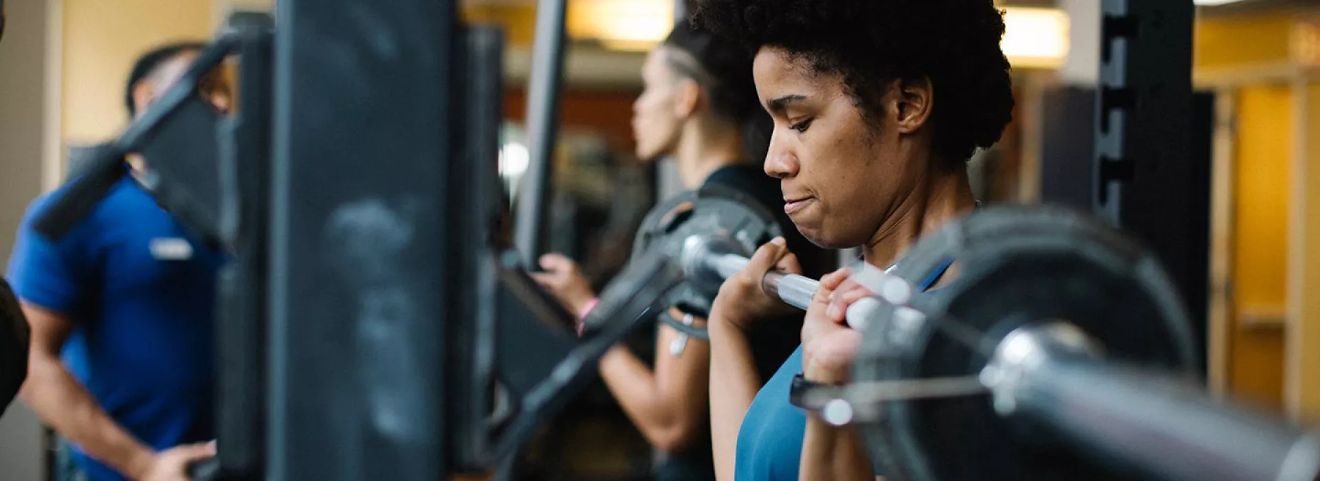 Woman lifting weights at Ridgewood YMCA in Queens