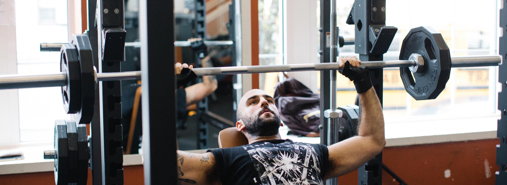 Man bench pressing weights at the Ridgewood YMCA
