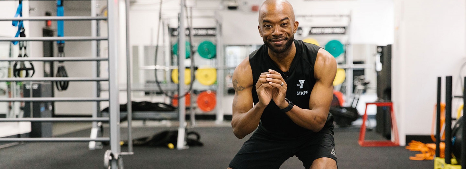 A YMCA instructor works out with no equipment.