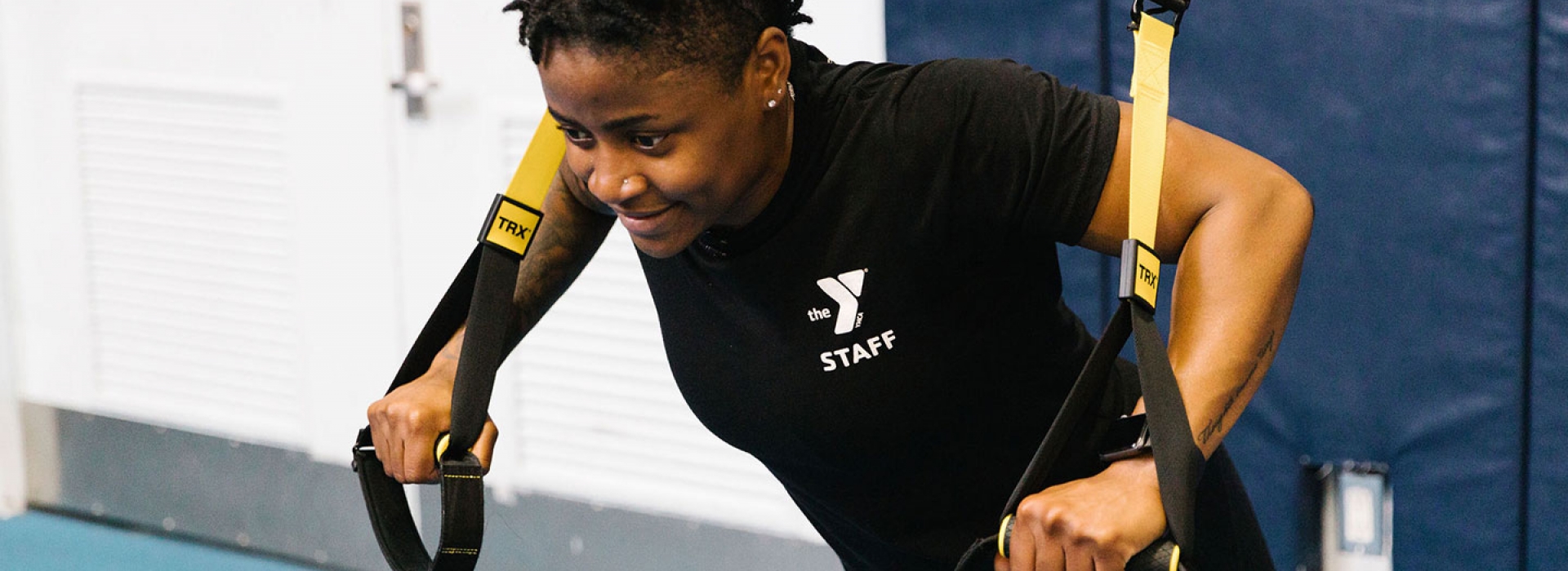 YMCA instructor demonstrates TRX