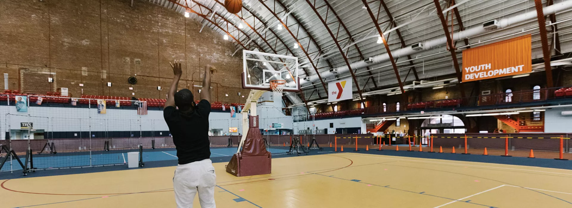 A YMCA member shoots a basketball in the gymnasium at the Y.
