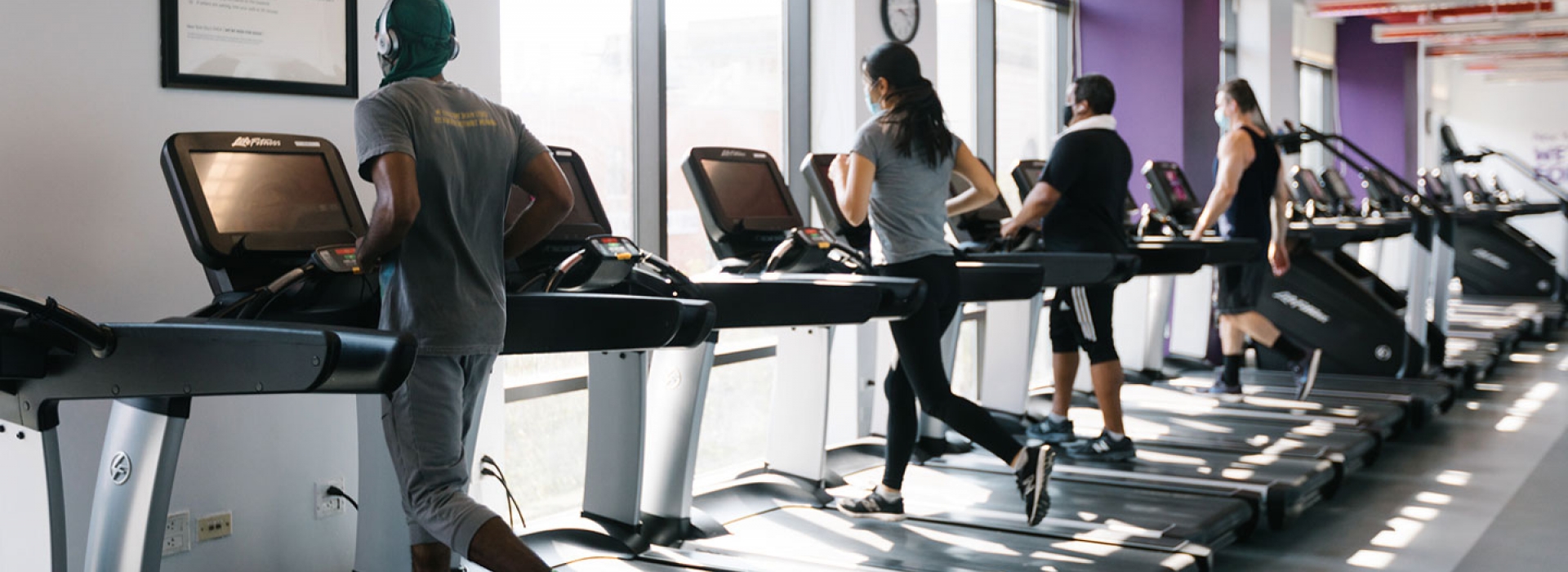 YMCA members in masks run on spaced out treadmills.