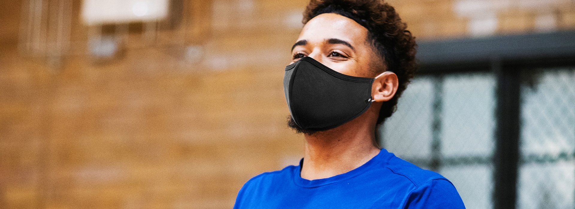 A staff member wearing a mask inside the gym