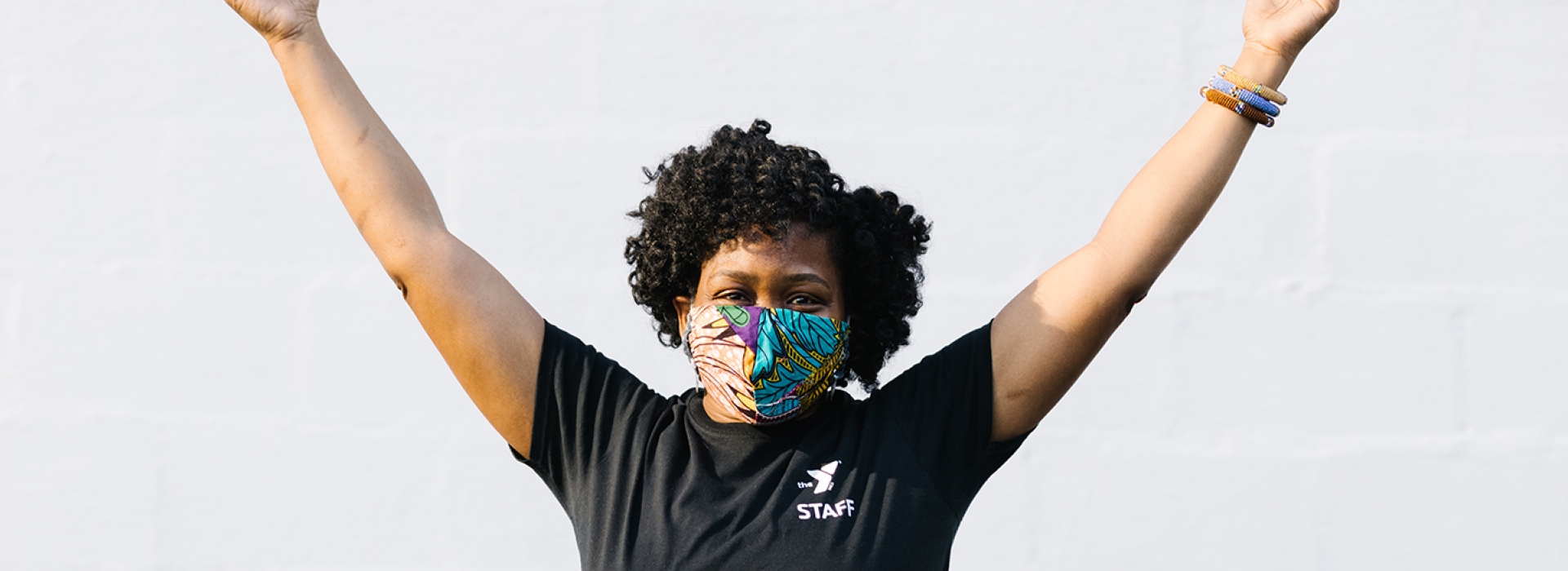 A woman wearing a mask doing yoga outside