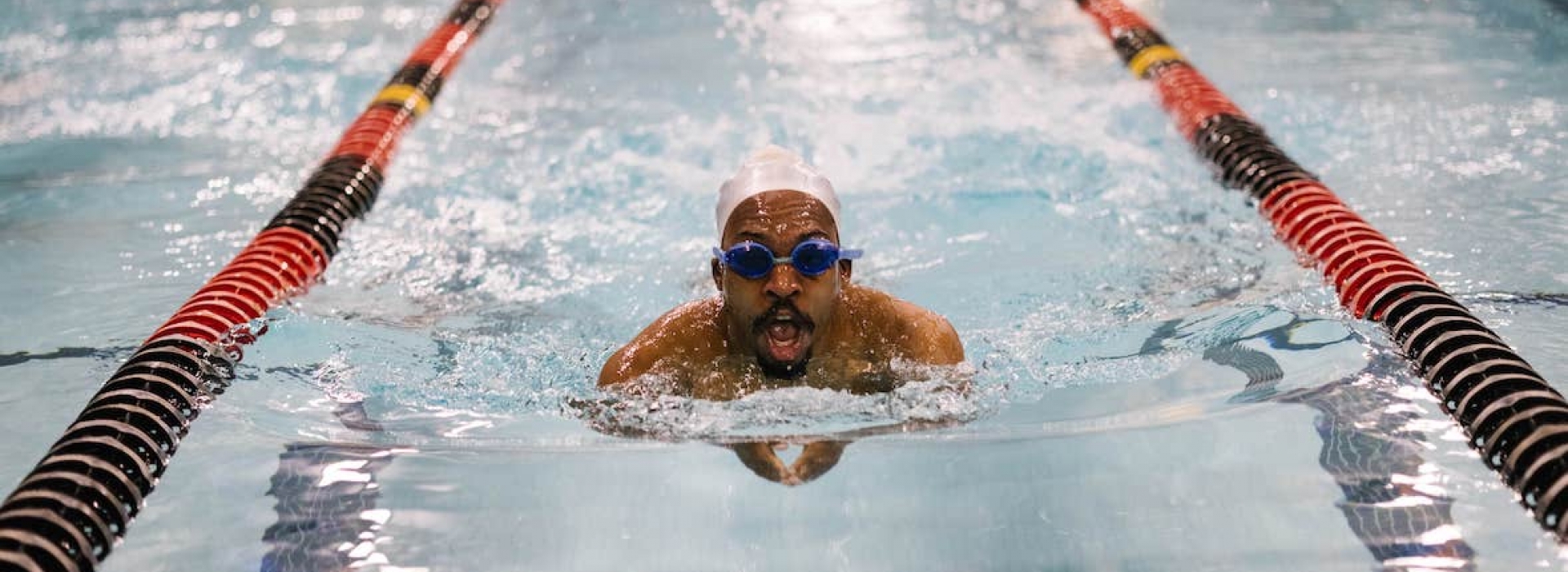 Man swimming laps at the YMCA of Greater New York pool