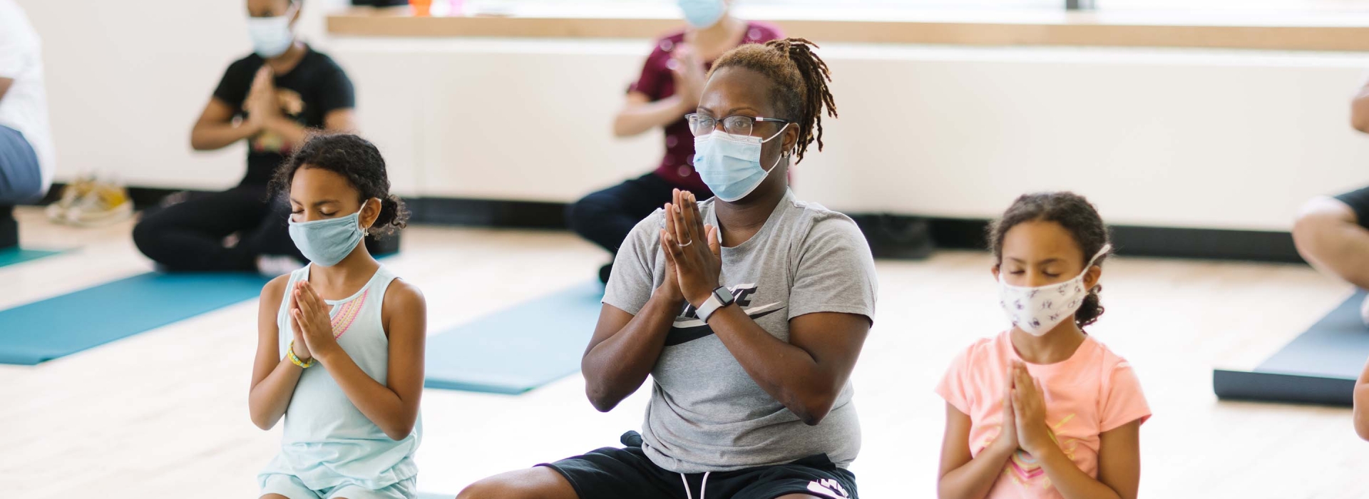 woman with two kids doing yoga
