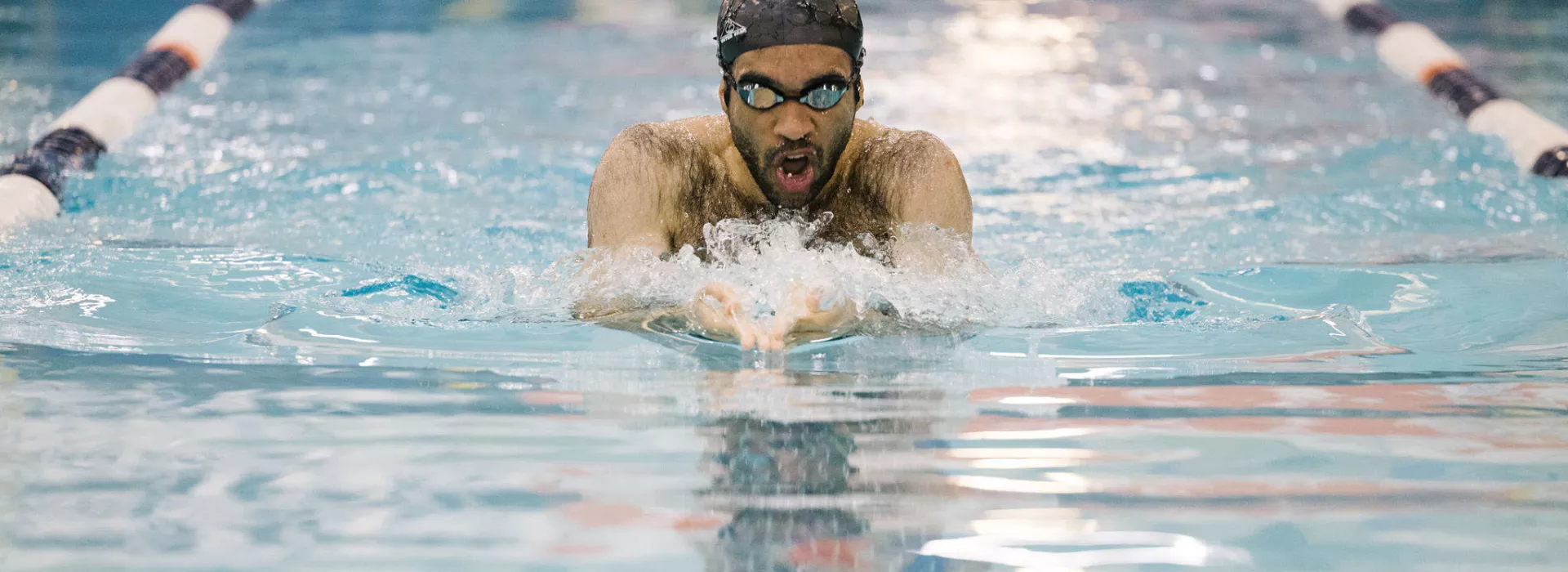 man swimming in a pool lane