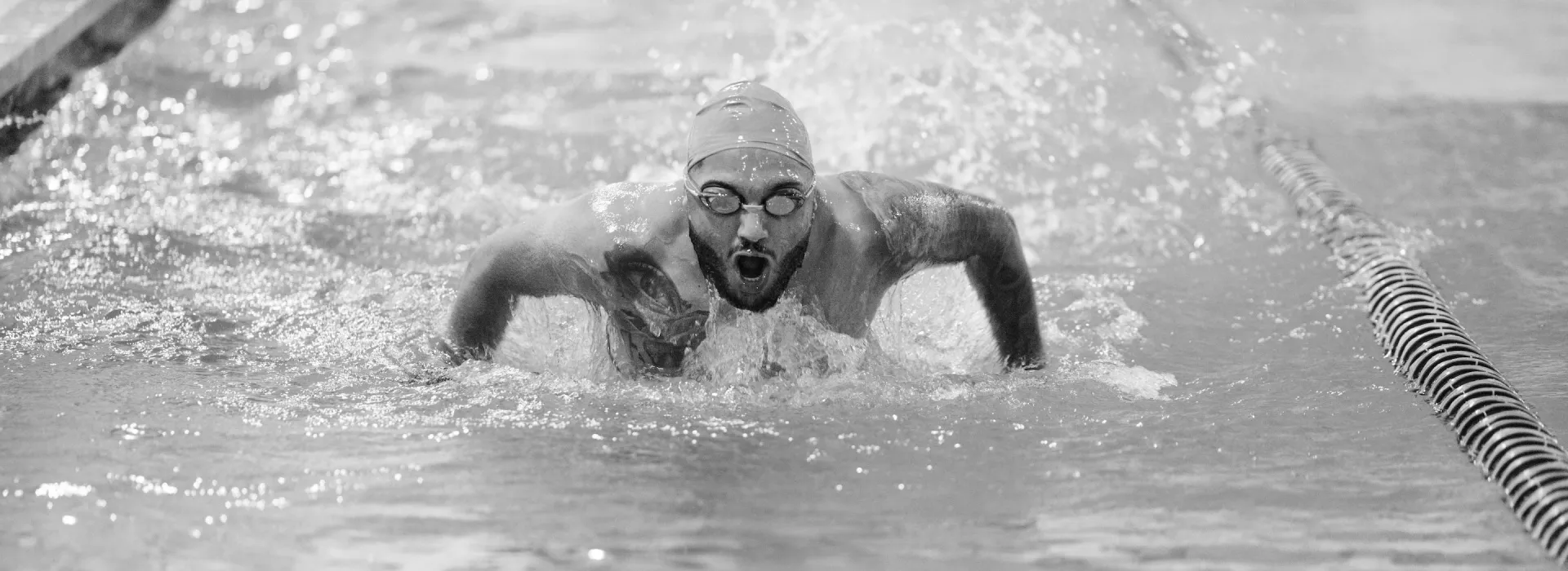man swims in pool