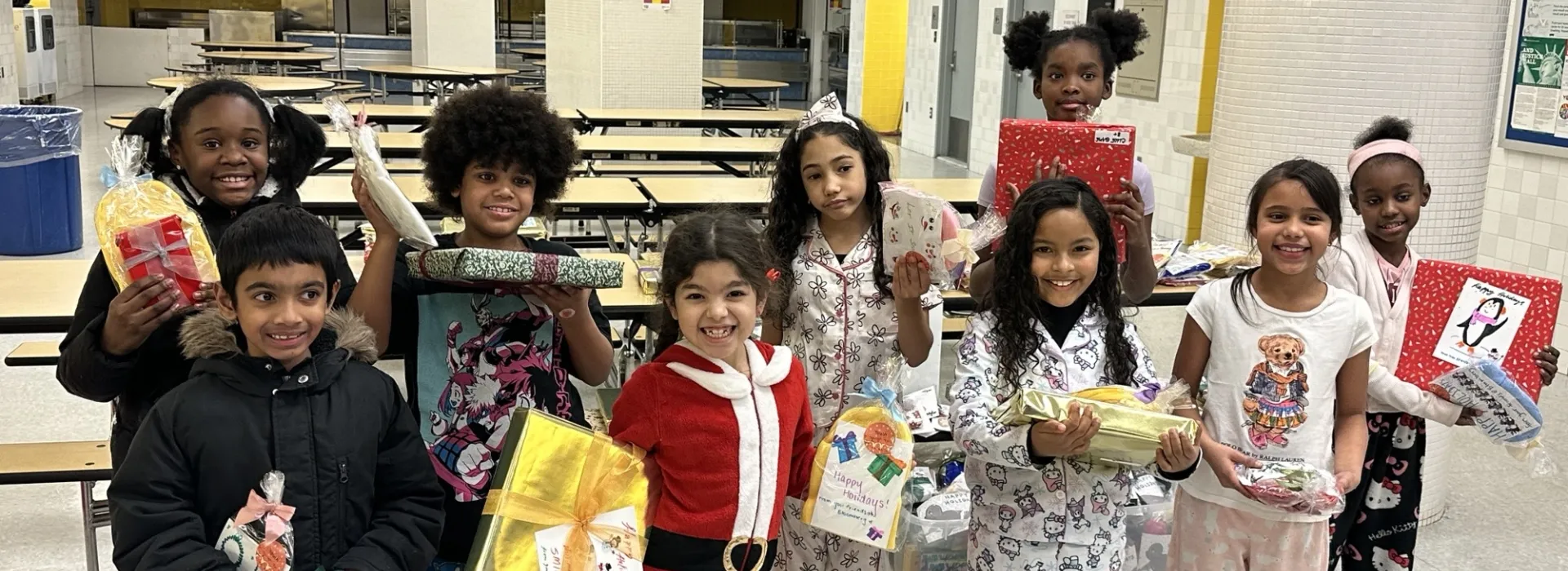 Kids pose with toys at West Side thanks to Bloomberg