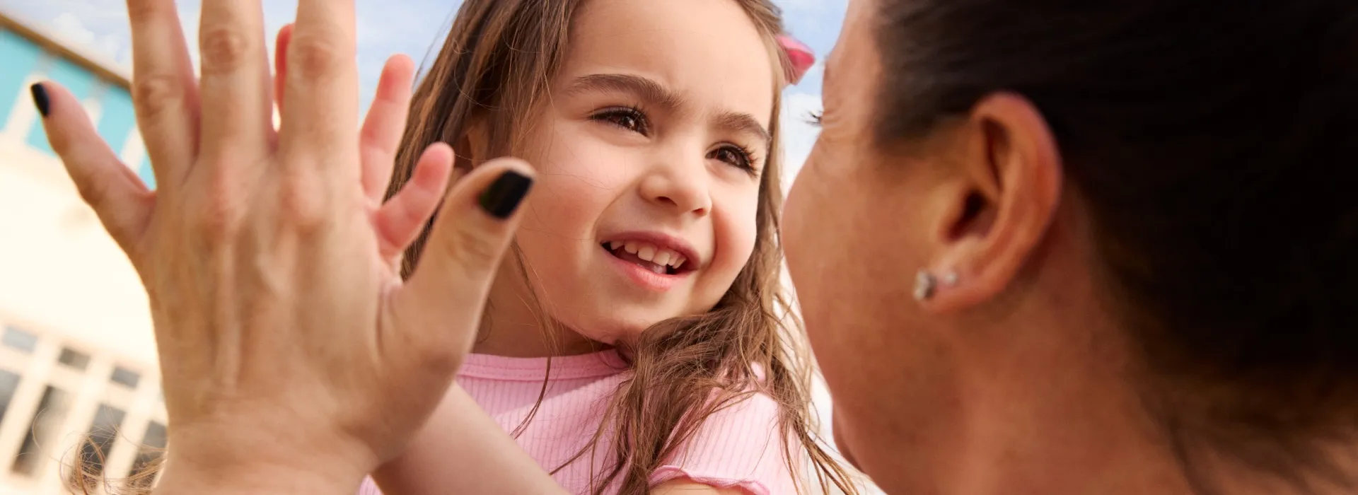 Young child embracing with caregiver or parent.