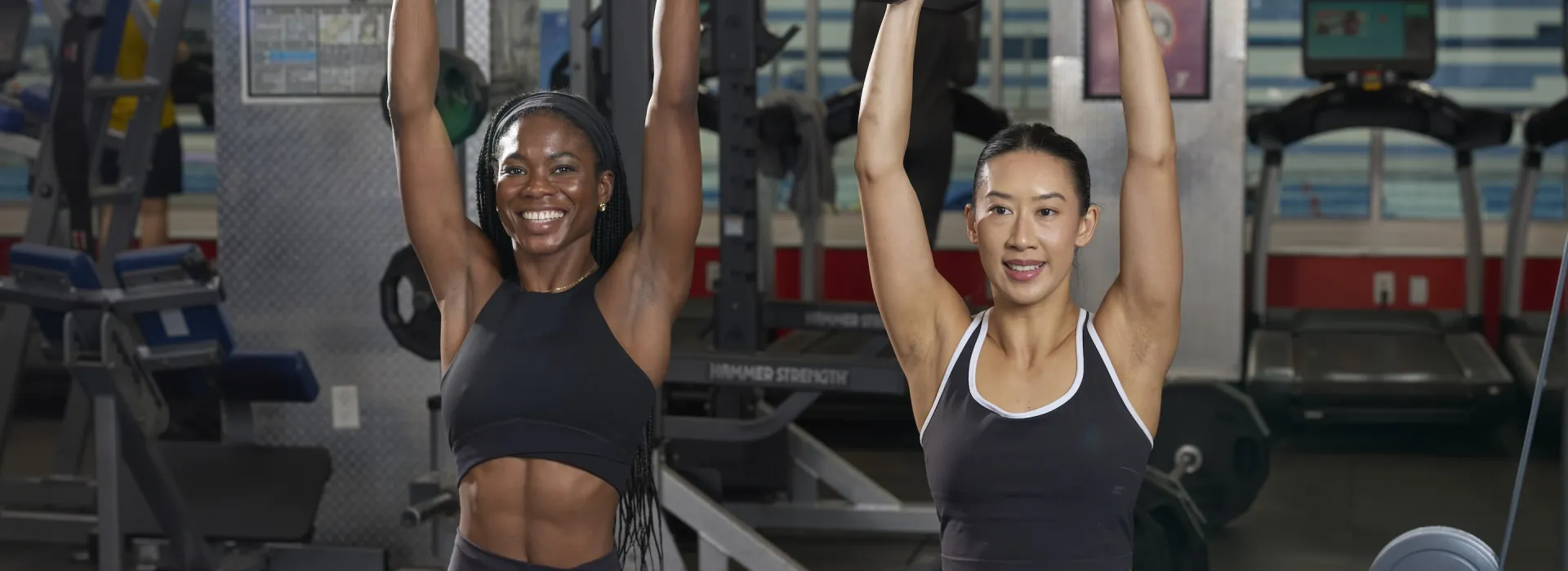 2 women lifting weights